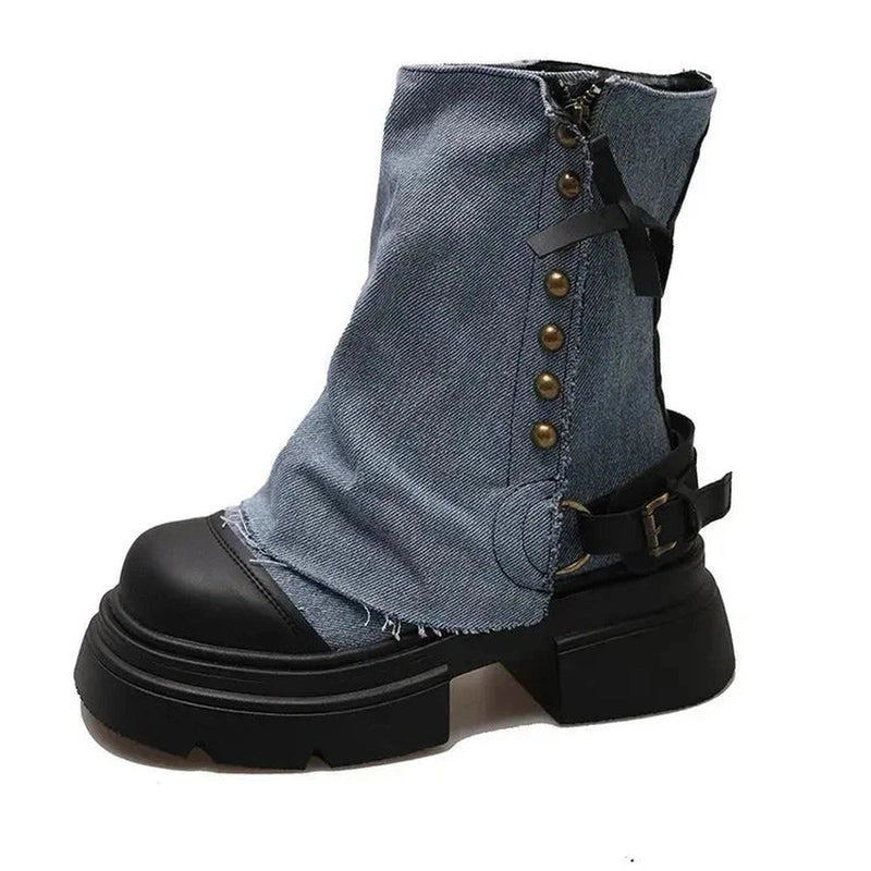 Single blue denim boot with block heel, brass buttons and side strap in focus.