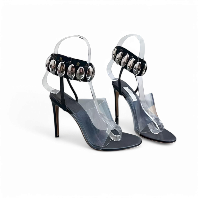 Frontal pair of ankle-strap sandals with clear vamps and metallic accents.