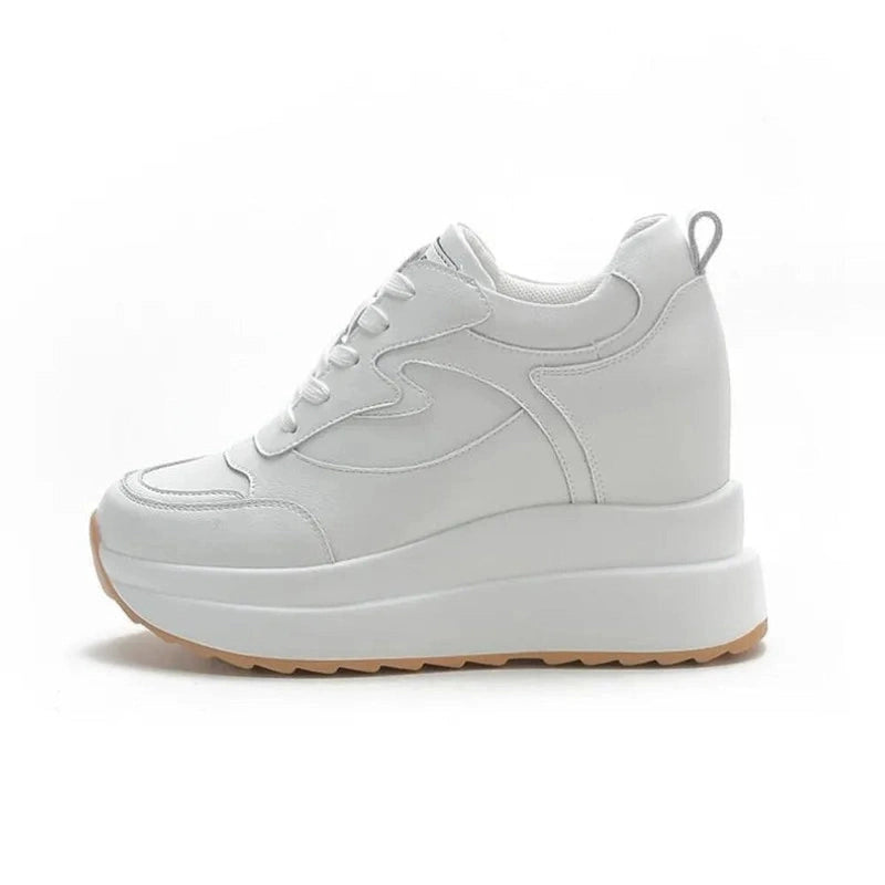 White sneaker with full 10 cm platform, pure white background.

