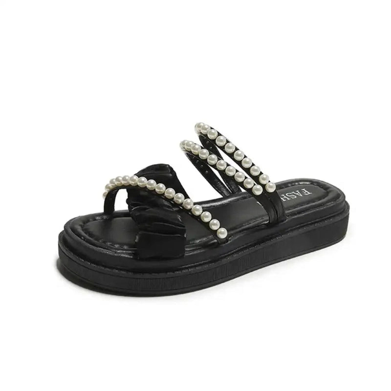 Black open-toe sandal with multiple pearl-trim straps, front-angled view on white background
