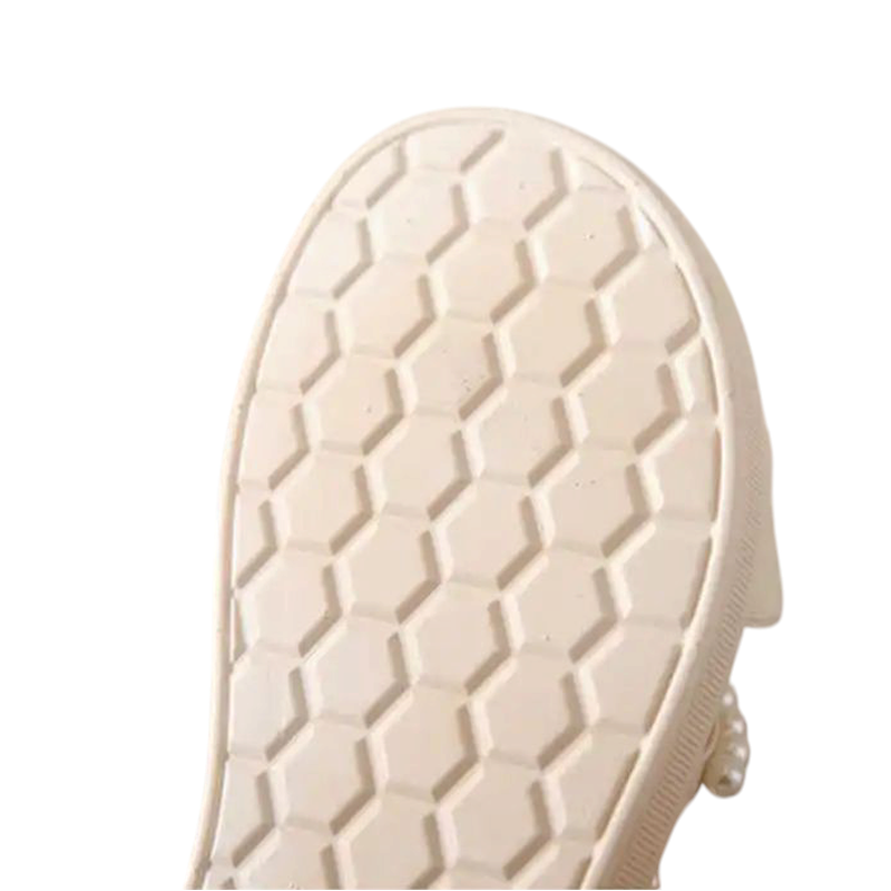 Close-up of ivory rubber outsole with hexagonal anti-slip pattern