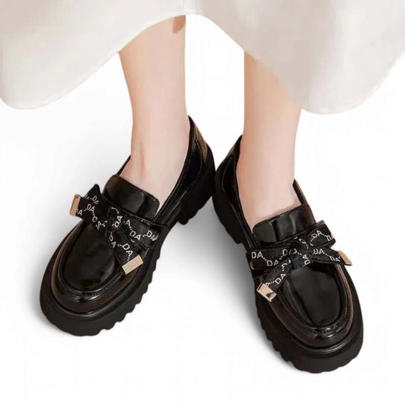 Lug-platform loafer worn with a short white dress, front angle.