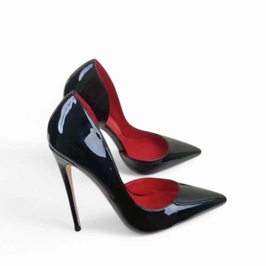 Profile of single black patent pump showing curved d’Orsay cut and high stiletto heel
