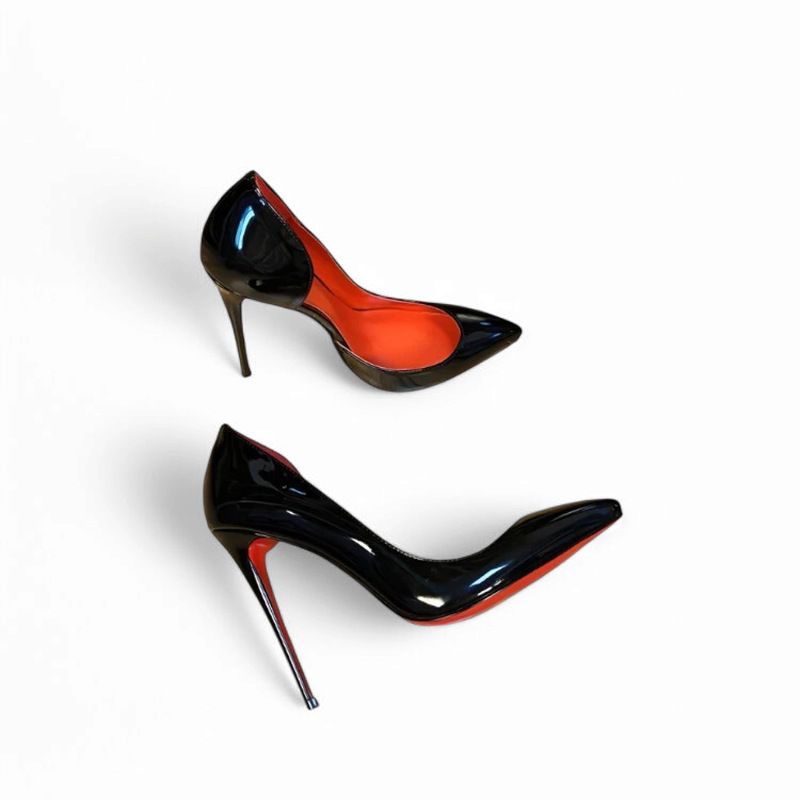 Two black patent pumps with red interior and outsole, side view on white