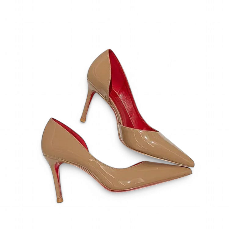 Nude patent pumps with pointed toes and red lining, angled view