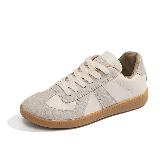 Low-top beige sneaker with suede overlays and light-brown gum sole.