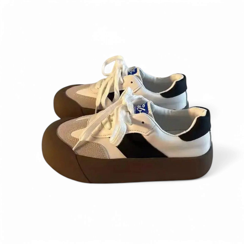 Black-and-brown sneaker pair on white background showing white laces.

