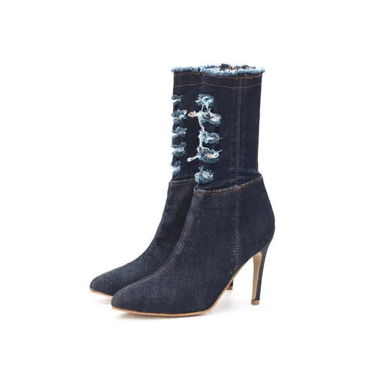 Dark-denim boots with stiletto heel and beige outsole, isolated product shot.