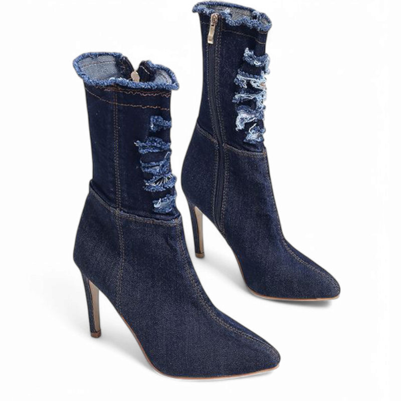 Dark-denim boots with slim heels and pointed toes, 45-degree side view.


