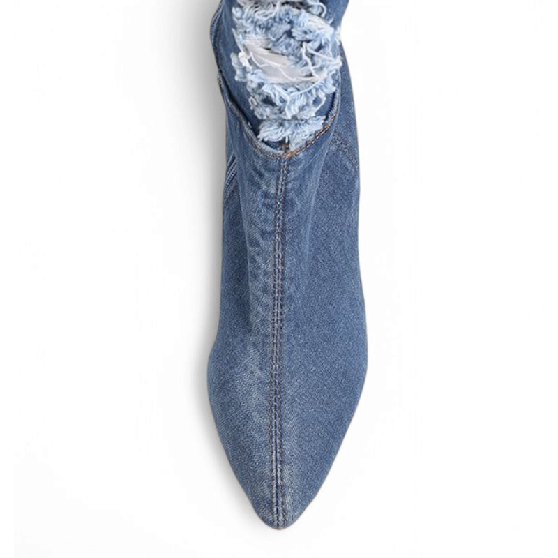 Light-blue denim boot with pointed toe seen from above, double stitching visible.

