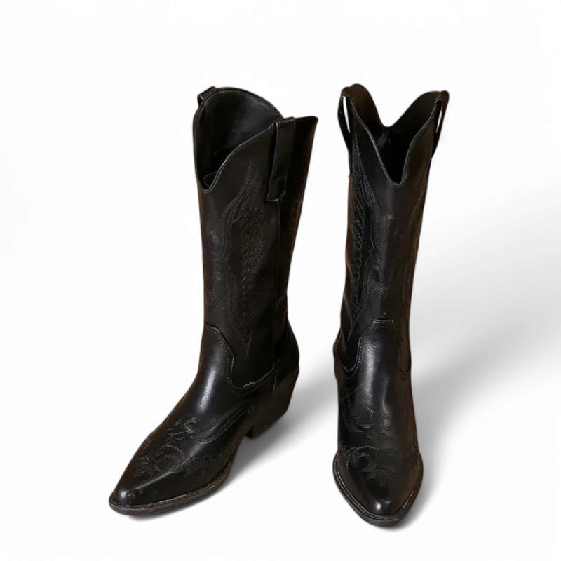 Black boot pair with pointed toes and deep-V top line, front angled view.