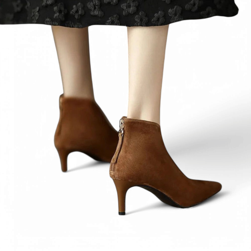 Pair of brown suede boots with slim heel, rear view showing closed zipper.

