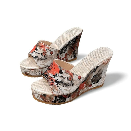 Three-quarter view of slip-on open-toe wedge platform sandals with red floral print on beige, shown as a pair.