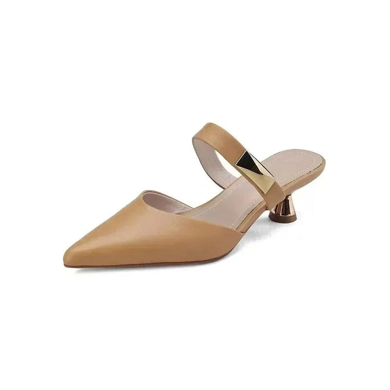 beige shoe isolated, highlighting gold strap and trumpet kitten heel.