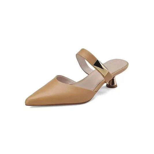 beige shoe isolated, highlighting gold strap and trumpet kitten heel.