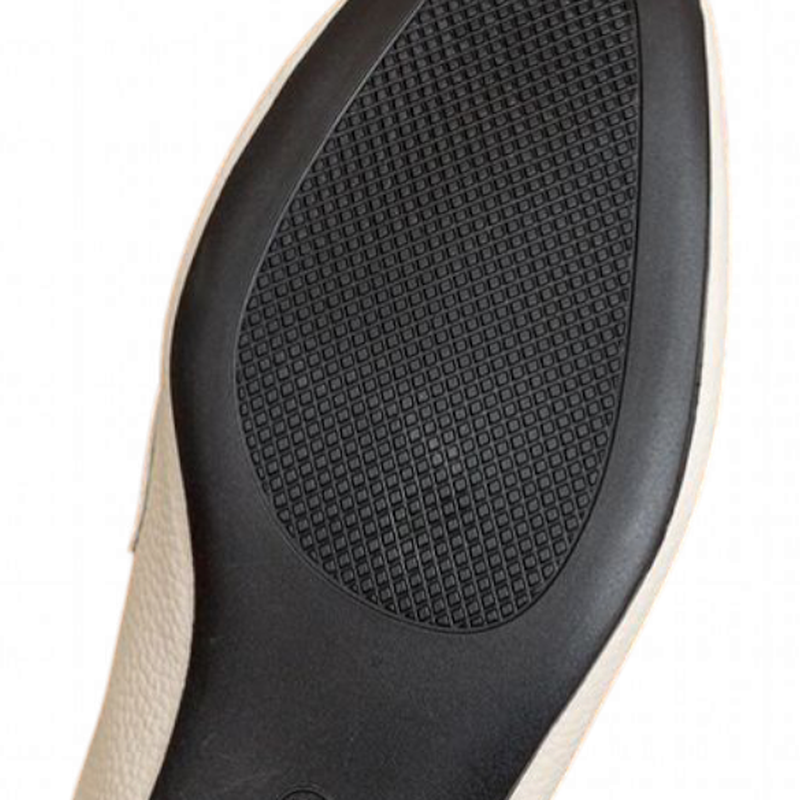Close view of textured black rubber outsole on ivory mule.