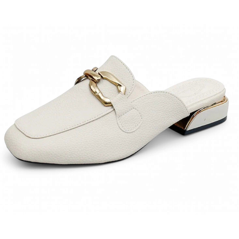 Side single view of ivory mule highlighting pebble-grain leather and gold heel cap.