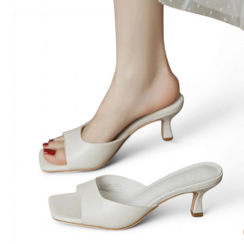 Quill Gray open-toe kitten-heel sandal worn by a model, extra pair in foreground, white background