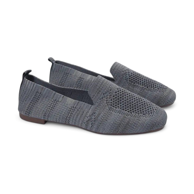 Three-quarter pair view of grey knit slip-on loafers with round toes and flat soles.