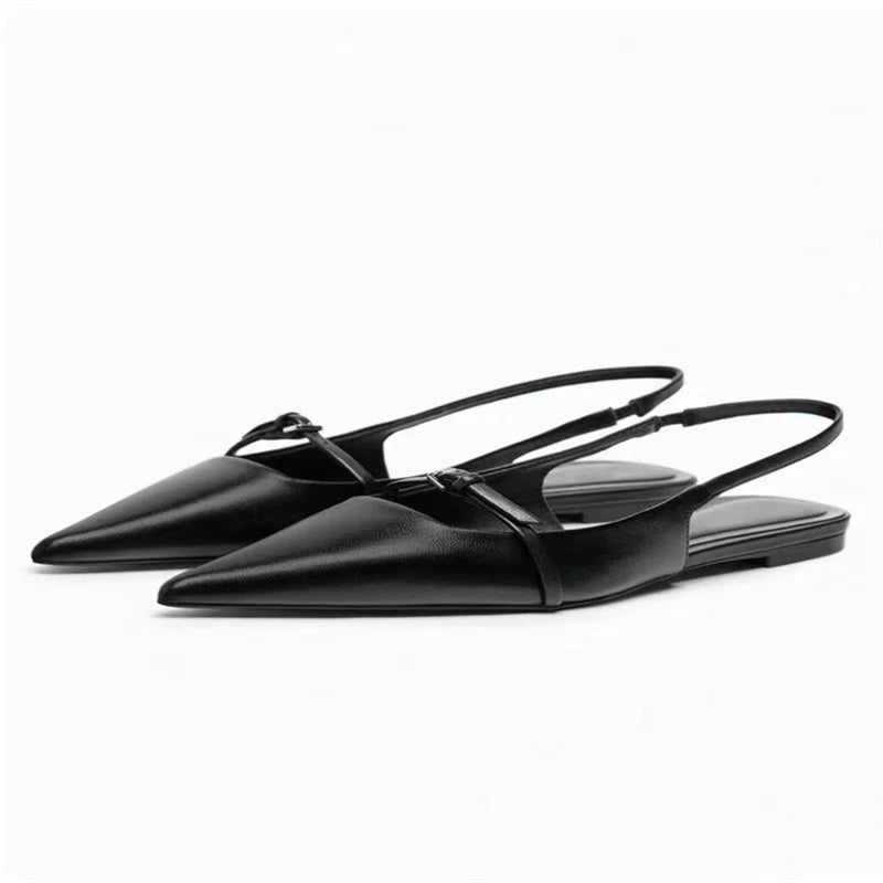  Two black flat slingback mules with pointed toes, shown in left 3‑quarter view