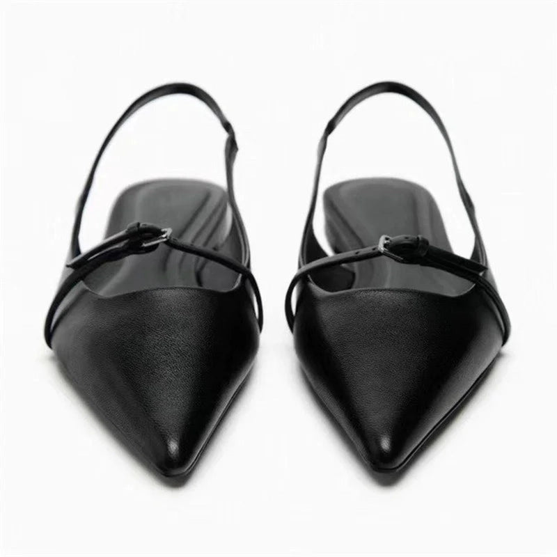Pair of black pointed slingback mules with two slim straps, front view on white background