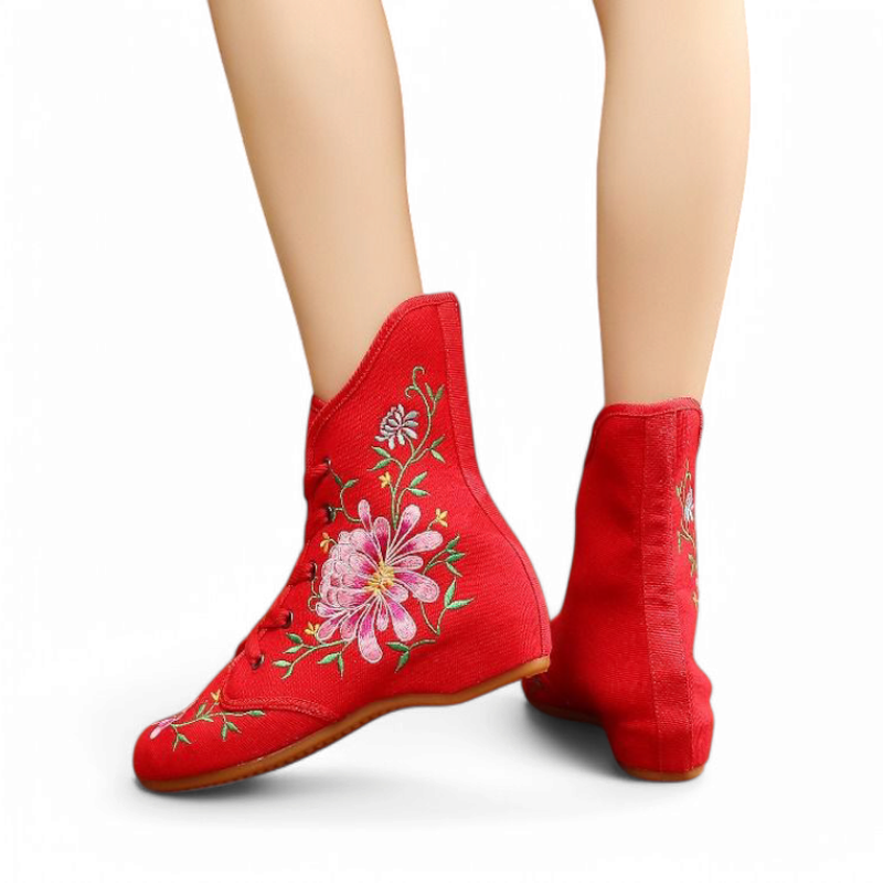 Red floral-embroidered boot showing canvas texture and gentle wedge line.
