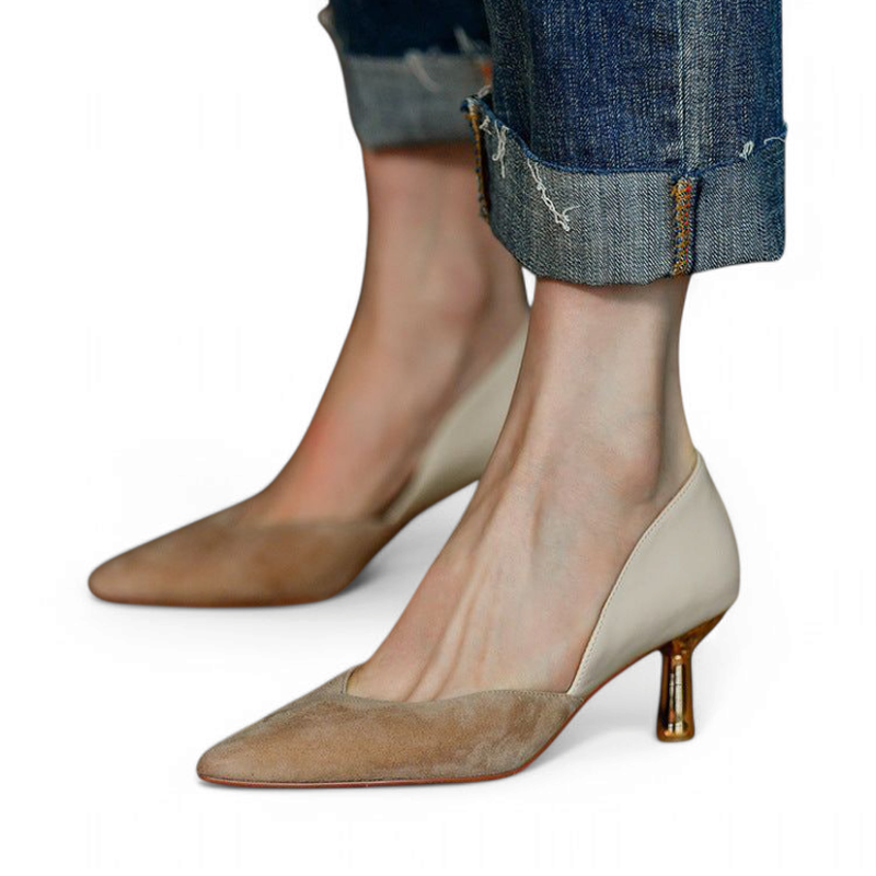 Both feet wearing pumps, cream back panel and bronze heel visible