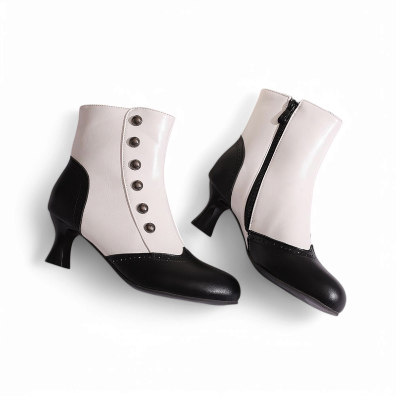 Two Victorian-style ankle boots in black and white, positioned lying flat on a white surface with one slightly angled beside the other.