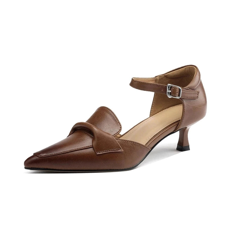 Studio shot of chocolate smooth-leather pump with decorative fold, ankle strap and mid kitten heel.