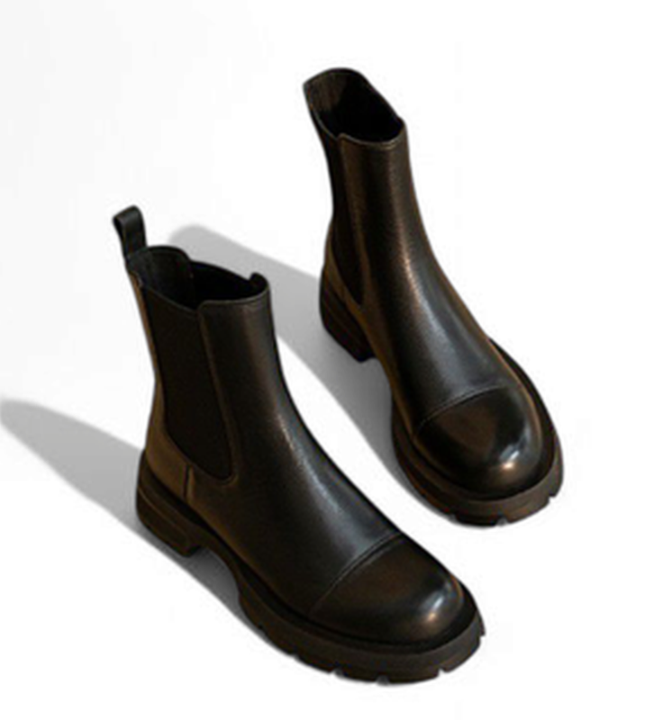 Overhead view of black Chelsea boots pair on white background