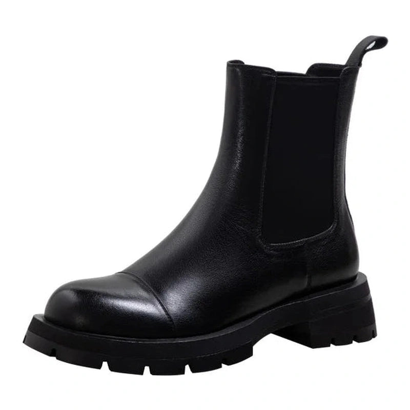Side angle of black Chelsea boot with thick sole visible