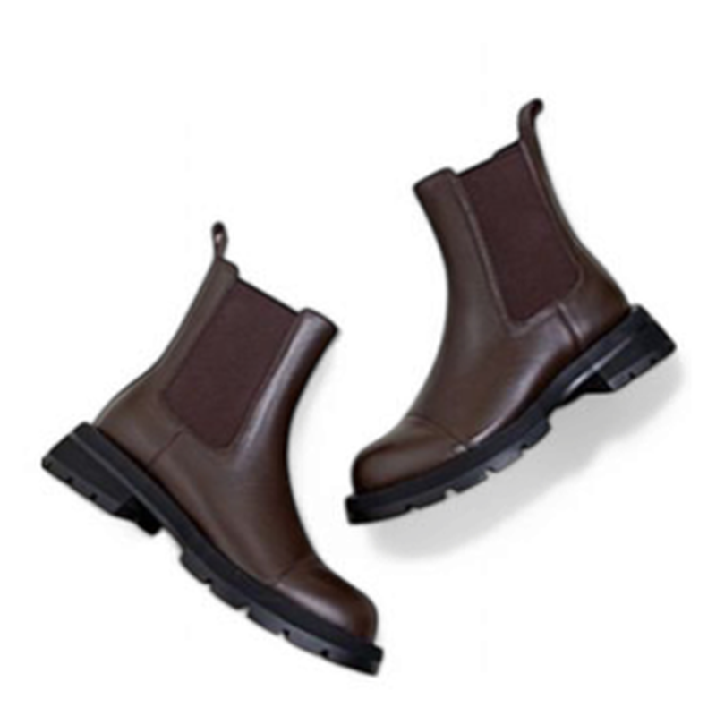 Brown Chelsea boots pair flipped sideways on white background