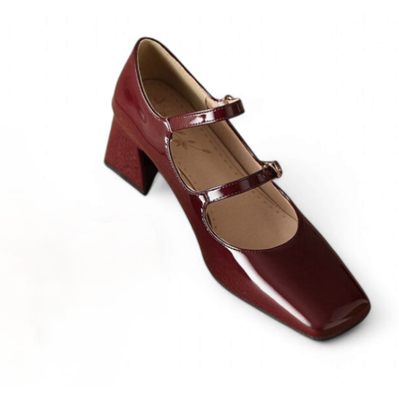 Glossy burgundy shoe with square toe, sturdy heel and two gold buckles