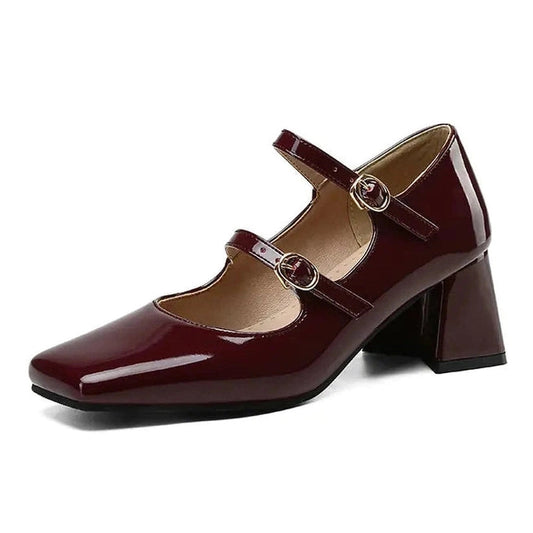 Single burgundy shoe on white background emphasizing wine hue and block heel
