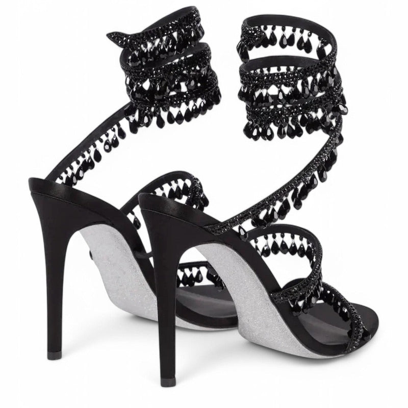 Rear view of black satin sandal with dangling black crystals and silver sole