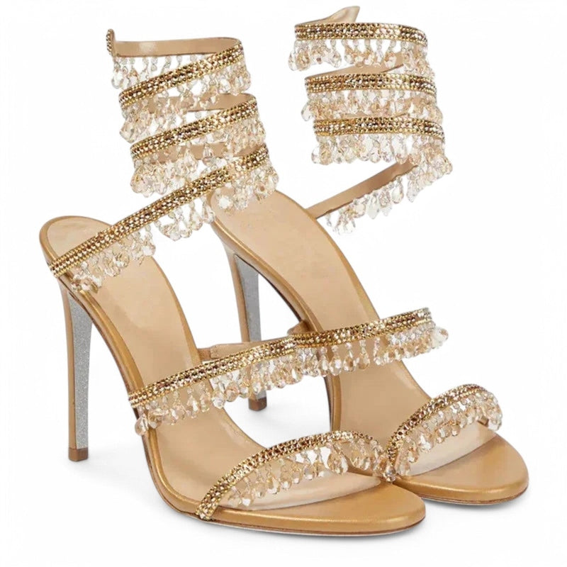 Pair of gold satin sandals, crystal fringes along straps, angled front view