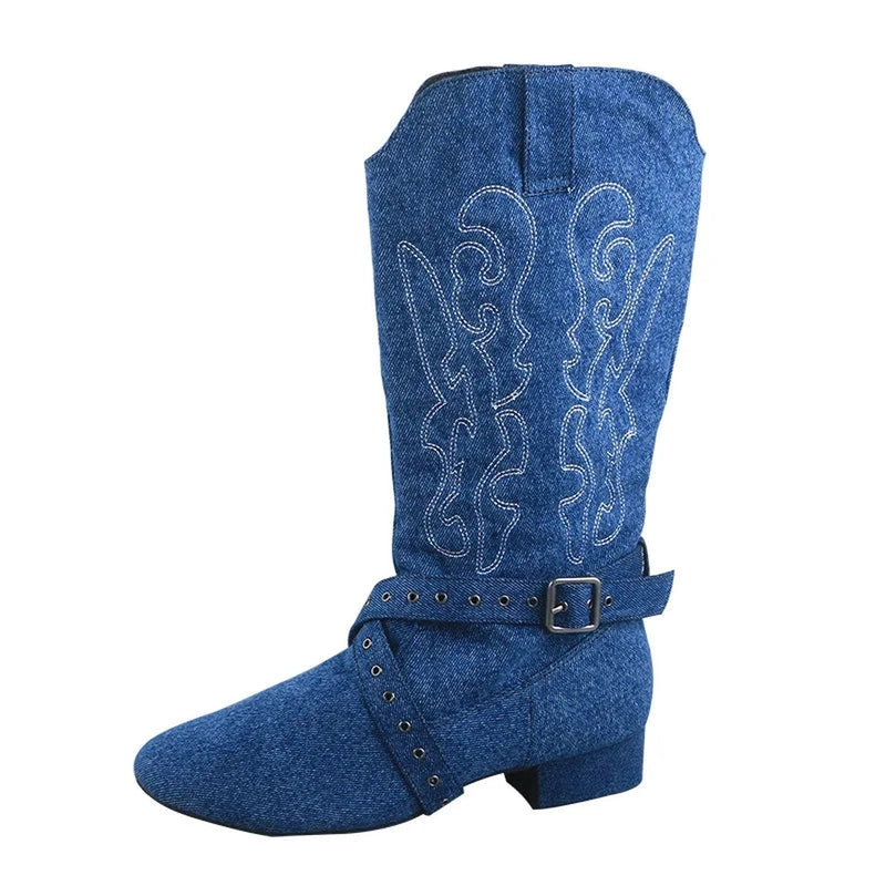 Blue denim boot with pull tabs, wavy embroidery and buckle strap at ankle.