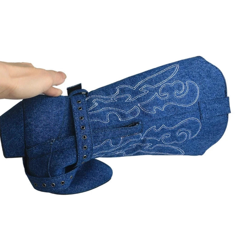 Folded denim boot showing shaft flexibility, white stitching and grommet belt.