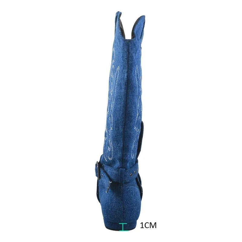 Mid-calf denim boot with white embroidery and low block heel marked 1 cm.