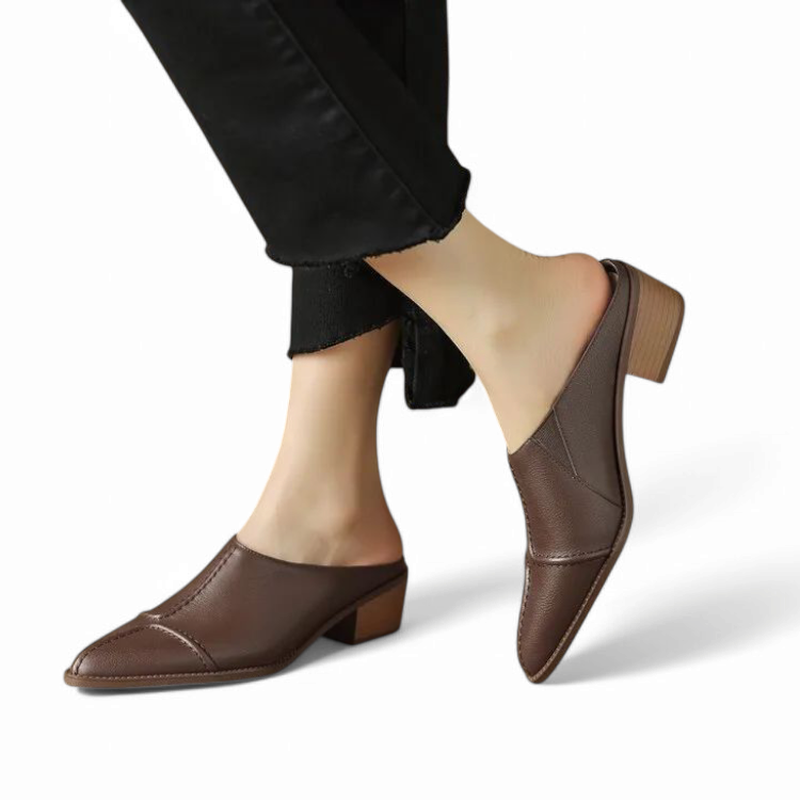 Side on-foot view of brown pointed-toe mule mid step.