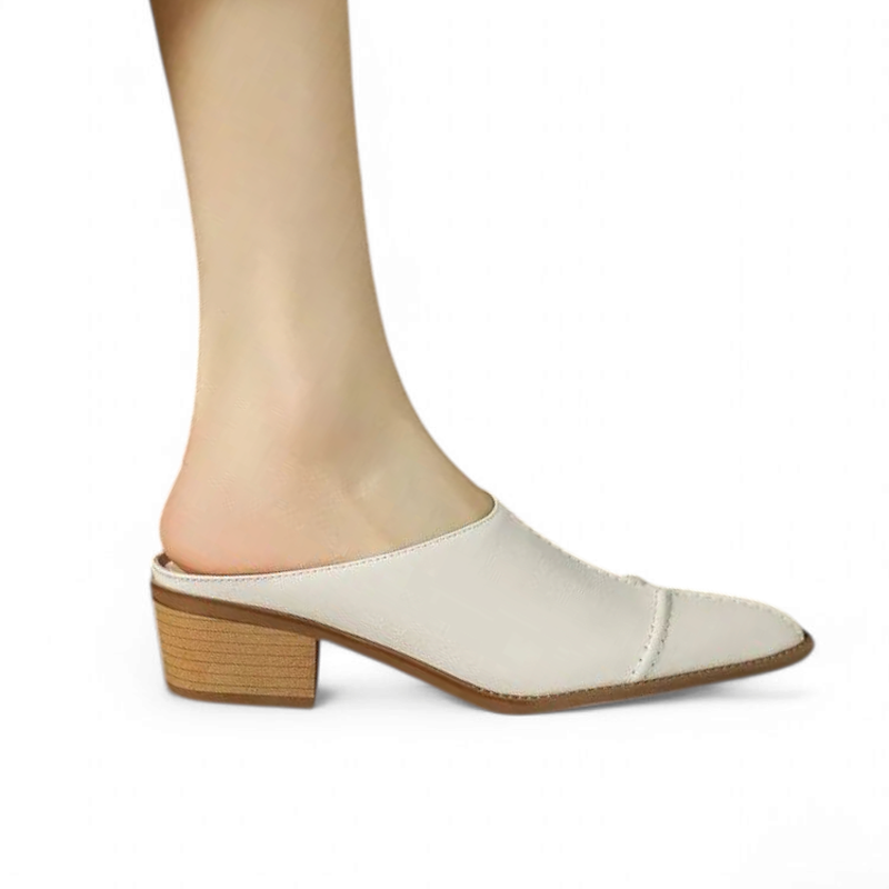 Side profile on-foot view of ivory pointed-toe mule with mid block heel.	