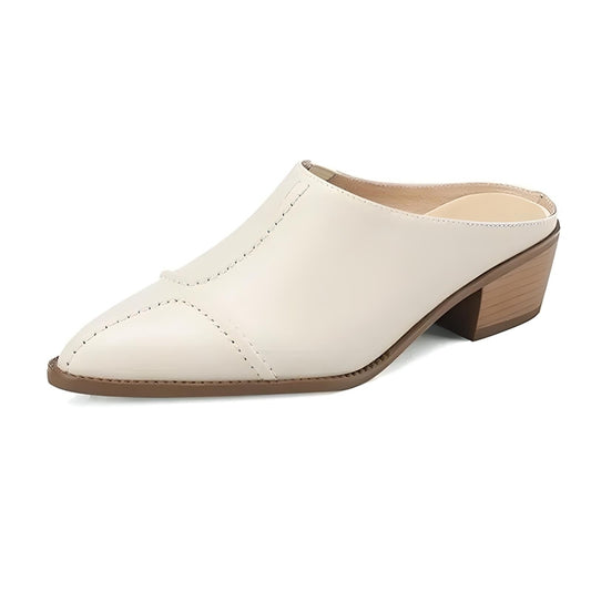 Studio side view of ivory mule with stitched panels and mid block heel.