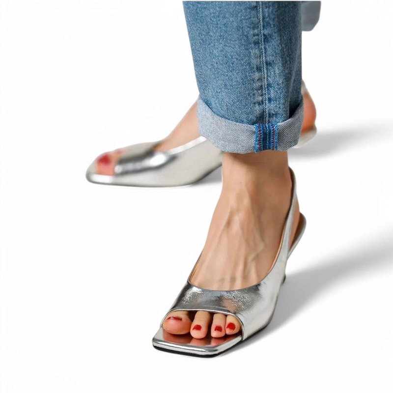 Silver square-open-toe slingback with kitten heel worn with rolled jeans, front view