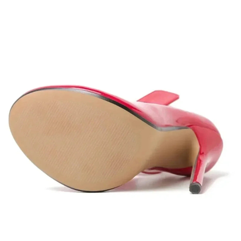 Underside view of a red pump displaying smooth rubber sole.
