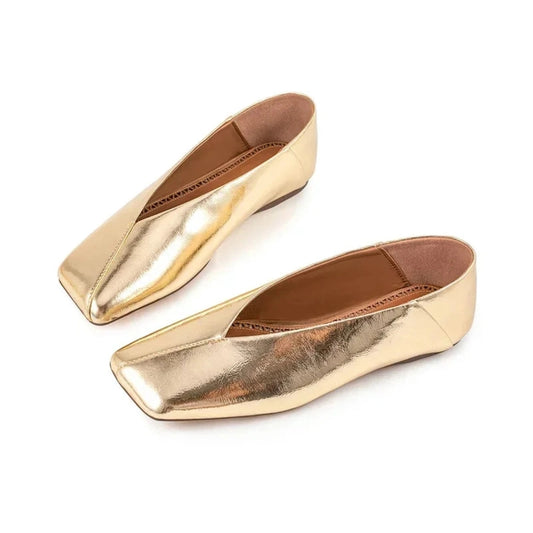 Gold metallic square-toe flats on white background
