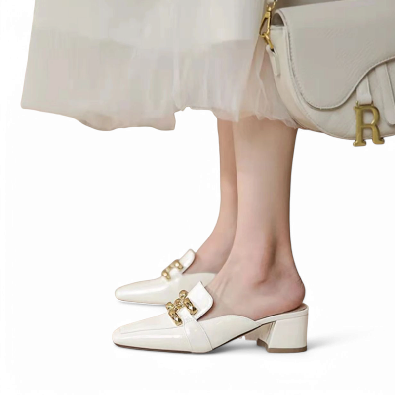 Mid‑heel ivory mules worn with a light chiffon dress