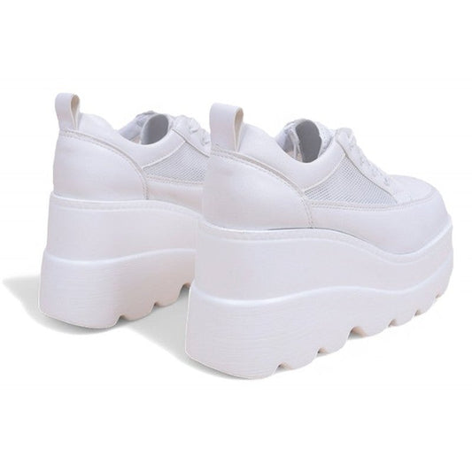 Pair of white platform sneakers with scalloped outsole, rear view showing double-layer wedge.