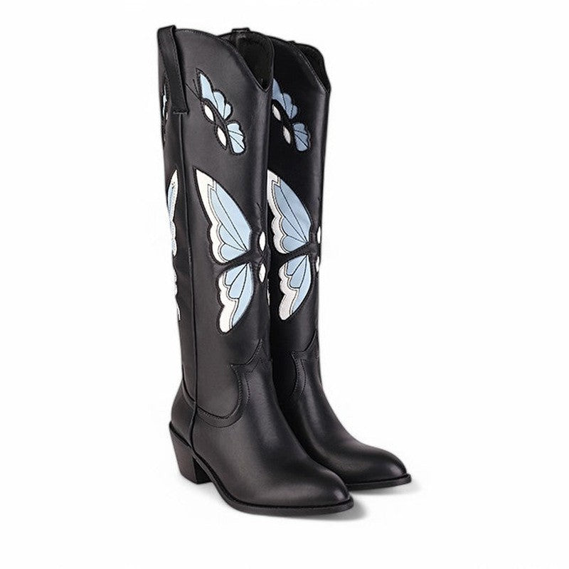 Pair of black knee-high boots with blue butterflies on white background.

