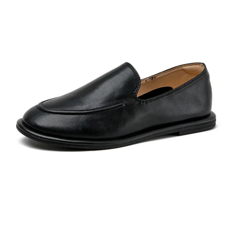 Single black loafer angled on white background