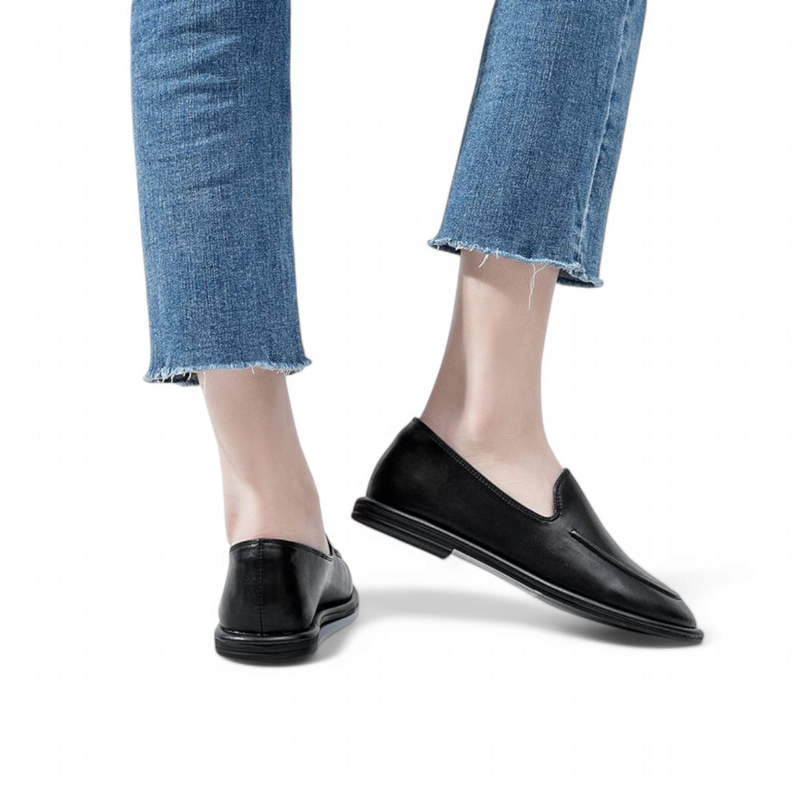 Pair of black loafers shown from back‑side while walking